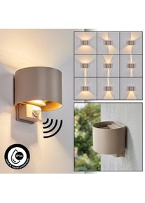hofstein Tamarin LED Up & Down Au&szlig;enwandleuchte mit Bewegungsmelder aus Metall sandfarben IP54 zylindrische Form, verstellbarer Lichtkegel durch Klappen, 3000 Kelvin, 350 Lumen, 6 Watt